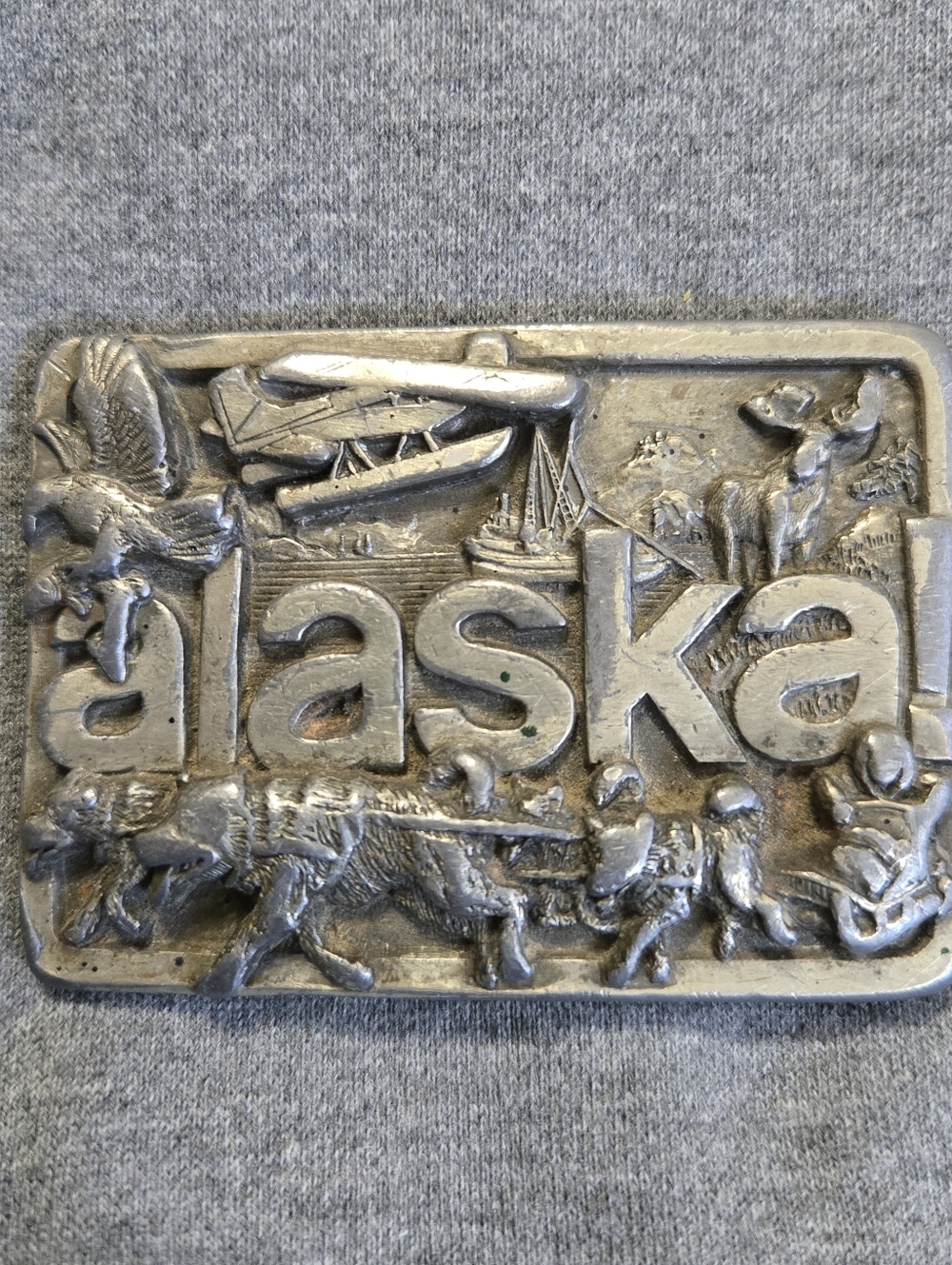 Vintage 1984 Solid Pewter Metal Alaska Montage Belt Buckle J & H Sled  Dog Plane